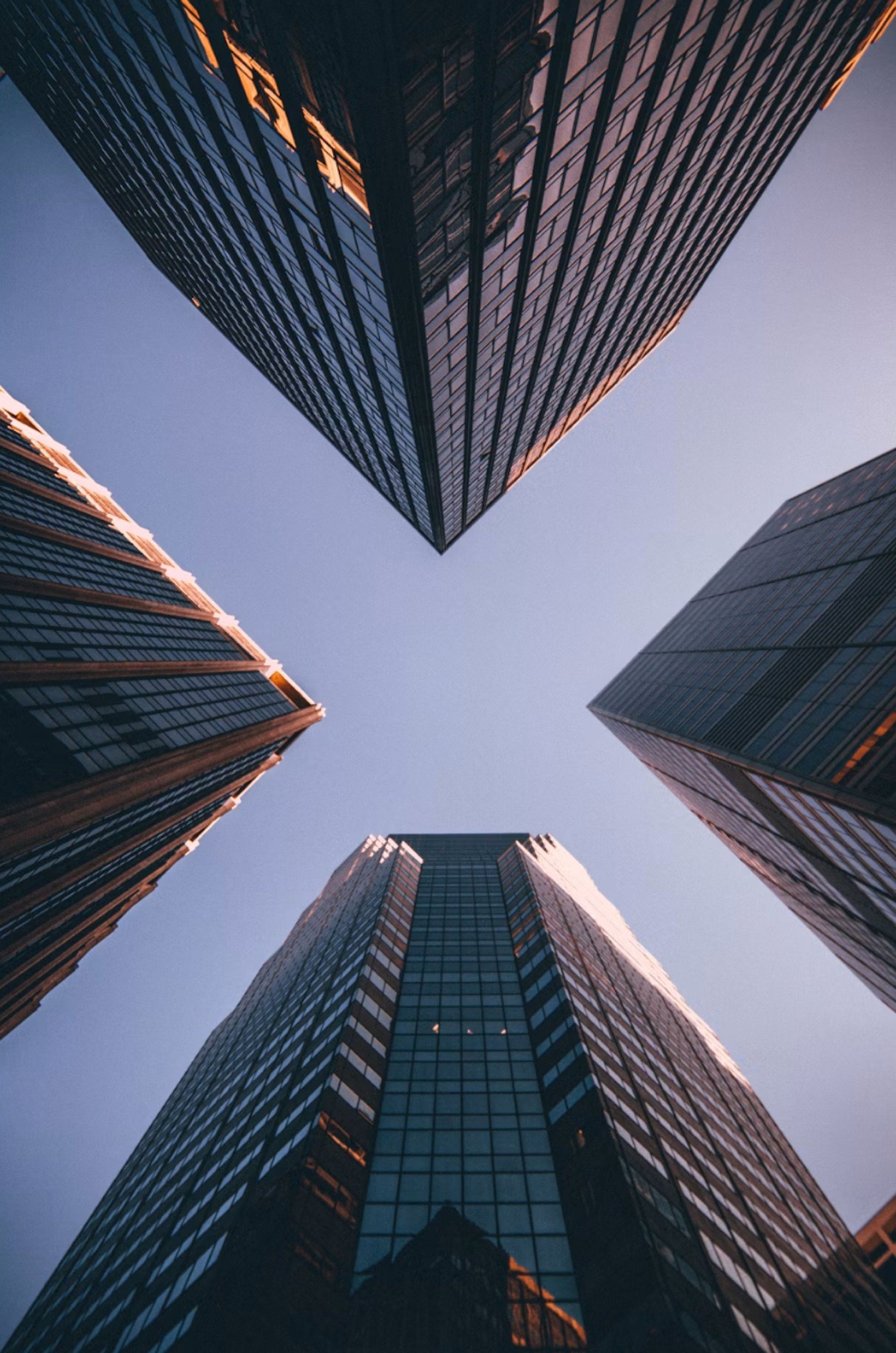 Upward view of high-rise towers, representing the scale and structure of long-term wealth